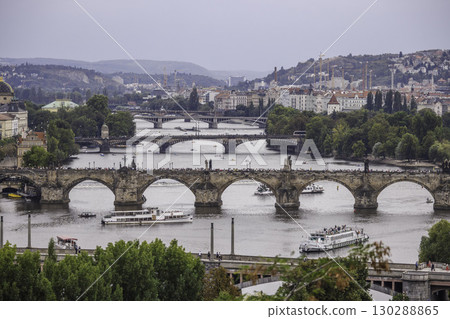 View of Charles Bridge and multiple bridges across the Vltava River in Prague with boats and cityscape in the background View of Charles Bridge and multiple bridges across the Vltava River in Prague with boats and cityscape in the background 130288865