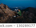 Photographer with Telephoto Lens Shooting at Mountain Sunset 130289177