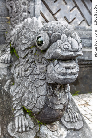Close-up of ornate stone guardian creature sculpture with glossy eyes at Khai Dinh Tomb in Hue Vietnam 130289256