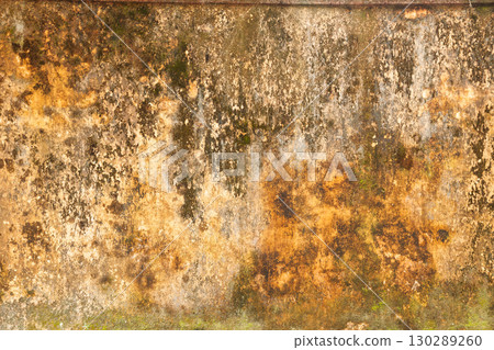 Grungy weathered yellow wall texture with peeling stains and mold in Hue Vietnam Grungy weathered yellow wall texture with peeling stains and mold in Hue Vietnam 130289260