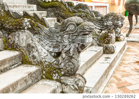 Intricately carved stone dragon sculptures on stair railing in Hue Imperial City Vietnam Intricately carved stone dragon sculptures on stair railing in Hue Imperial City Vietnam 130289262