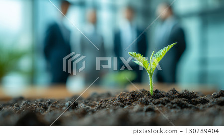 Young green plant growing in soil with blurred business people background symbolizing growth and success in teamwork and investment Young green plant growing in soil with blurred business people background symbolizing growth and success in teamwork and investment 130289404