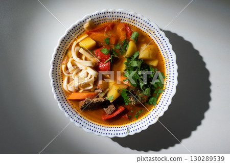 Warm and Hearty Lagman Soup With Meat and Vegetables Served in a Decorative Bowl 130289539