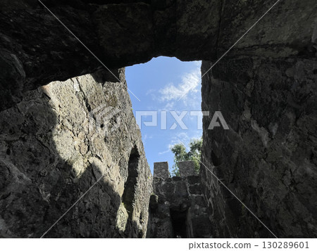 View of the blue sky through a window in a stone fortress 130289601