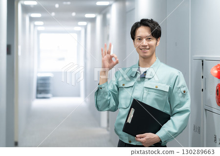 Young male engineer doing office maintenance Young male engineer doing office maintenance 130289663