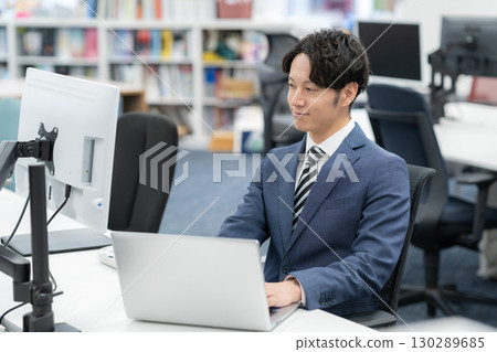 A young businessman working in the office A young businessman working in the office 130289685