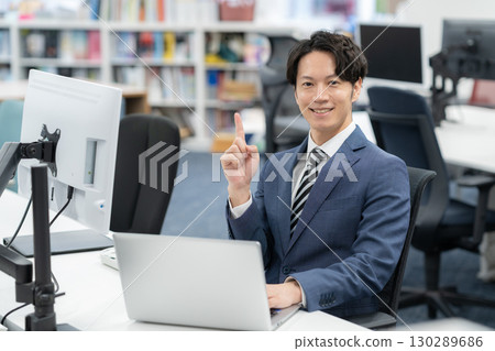 A young businessman working in the office A young businessman working in the office 130289686