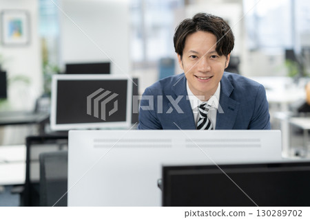 A young businessman working in the office 130289702