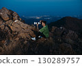Photographer with Telephoto Lens Shooting at Mountain Sunset 130289757