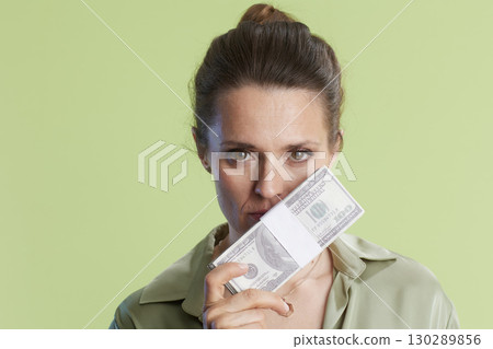 Woman hiding behind money stack 130289856