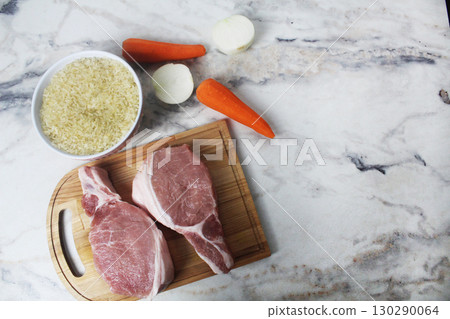 raw meat rice onion carrots with space for text copyspace 130290064
