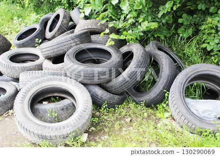 A dump of old car tires. The problem of recycling car tires A dump of old car tires. The problem of recycling car tires 130290069