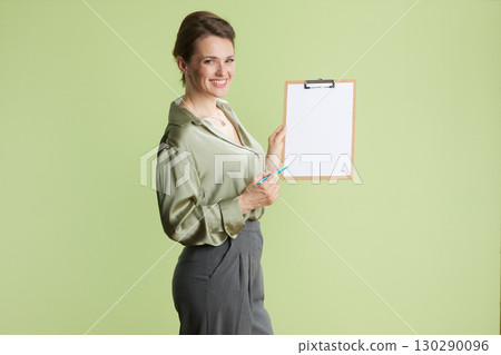 Confident woman presenting with clipboard Confident woman presenting with clipboard 130290096