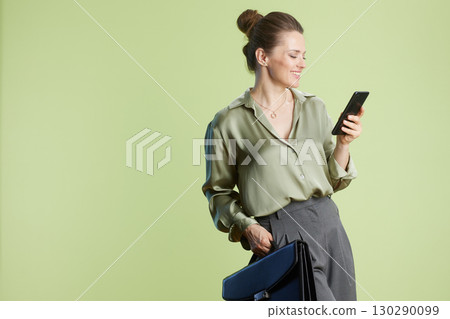 Relaxed professional: Woman looking at phone 130290099