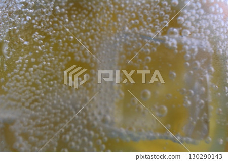 Lemonade water divorcing in a glass of ice and orange is very close-up. Macrophoto Lemonade water divorcing in a glass of ice and orange is very close-up. Macrophoto 130290143