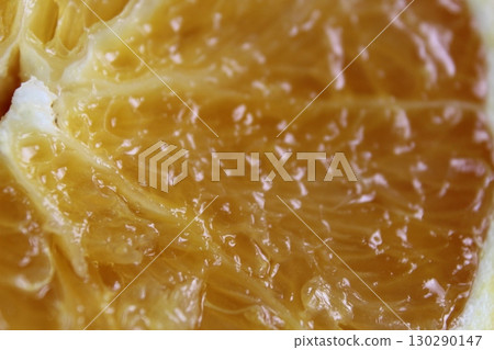 cut of the orange close-up. Macro photo of eating orange fruit. Orange fruit background 130290147