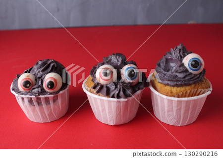 Monster Cupcakes on a red background. Food for a child Monster Cupcakes on a red background. Food for a child 130290216