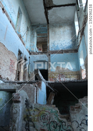 A destroyed house inside without ceilings and stairs. Vandalism, war, devastation A destroyed house inside without ceilings and stairs. Vandalism, war, devastation 130290238