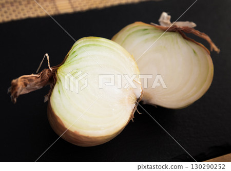 Tasty and healthy onion lies on the table Tasty and healthy onion lies on the table 130290252