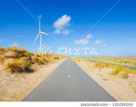 Green energy. Wind turbine on the seashore. Renewable and natural energy sources. 130290266