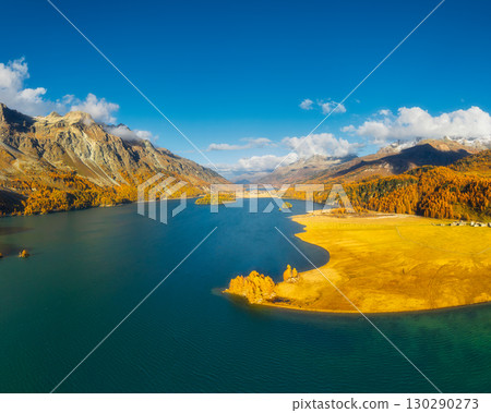 Drone view of a mountain and lake in the Engadin valley, Switzerland.  130290273