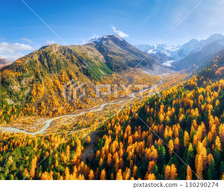 Drone view of a mountain valley. River in the middle of the forest. Autumn landscape from the air. 130290274