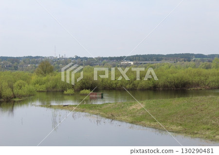 spilling the river in spring on the plain. The river came out of the banks. Natural phenomenon spilling the river in spring on the plain. The river came out of the banks. Natural phenomenon 130290481