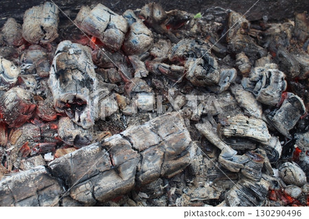 background and ash charcoal gray blacks with red stained streaks close-up. The aftermath of the fire. Ashes. bonfire 130290496
