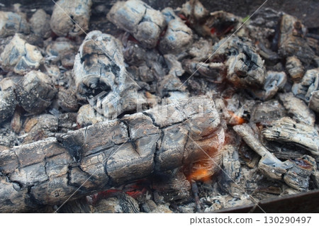 background and ash charcoal gray blacks with red stained streaks close-up. The aftermath of the fire. Ashes. bonfire 130290497