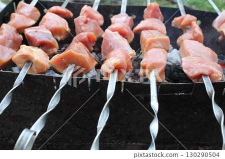 shashlik. Meat is cooked on skewers on coals. The cooking process. Picnic 130290504