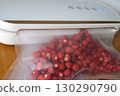 Vacuum sealer of strawberries, honeysuckle in bag, packaging for long-term storage . Vacuum packing machine 130290790