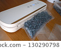 Vacuum sealer of strawberries, honeysuckle in bag, packaging for long-term storage . Vacuum packing machine 130290798