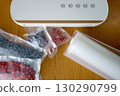 Vacuum sealer of strawberries, honeysuckle in bag, packaging for long-term storage . Vacuum packing machine 130290799