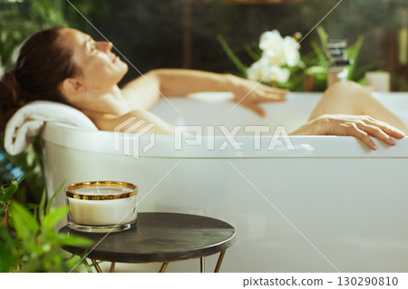 Woman Enjoying a Relaxing Candlelit Bath Woman Enjoying a Relaxing Candlelit Bath 130290810