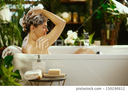 Mature Woman\'s Serene Hair Wash in a Bright Bath 130290812