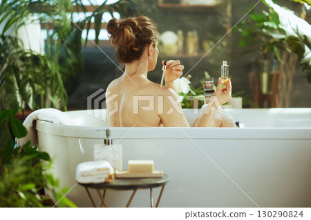 Woman Applying Skincare in a Serene Spa Bath Woman Applying Skincare in a Serene Spa Bath 130290824