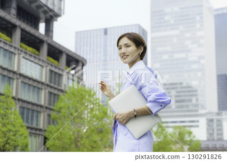 Portrait of a young businesswoman using a laptop in an office district 130291826