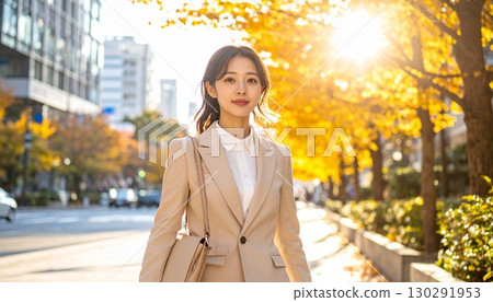 A Japanese business person in a suit with an early autumn cityscape as the background 130291953