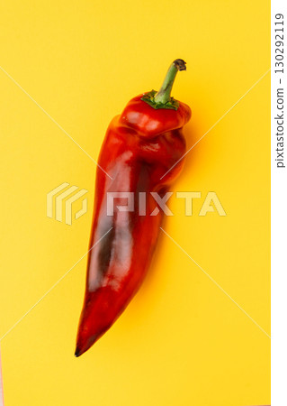 Red chili pepper on yellow background, fresh vegetable Red chili pepper on yellow background, fresh vegetable 130292119