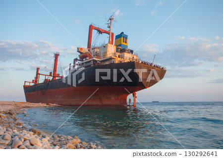 Stranded abandoned bulk ship on sea coast Stranded abandoned bulk ship on sea coast 130292641