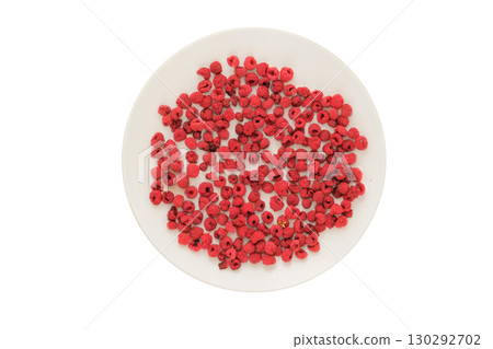 Top view. Lightweight food. Ingredient for preparing a freeze-dried breakfast. Dried raspberries on a white plate isolated on a white background. 130292702
