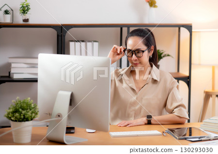 Young asian business woman working with desktop computer while thinking for planning financial. 130293030