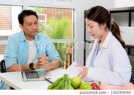 Asian nutritionist consulting patient in clinic, meal plan discussion, healthcare advice. Asian nutritionist consulting patient in clinic, meal plan discussion, healthcare advice. 130293040