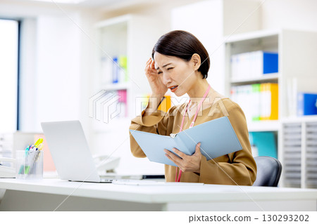 A woman notices a mistake at work 130293202