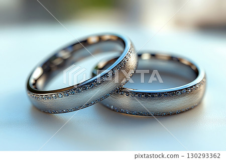 Pair of white gold wedding rings on a white background. Original style. Pair of white gold wedding rings on a white background. Original style. 130293362
