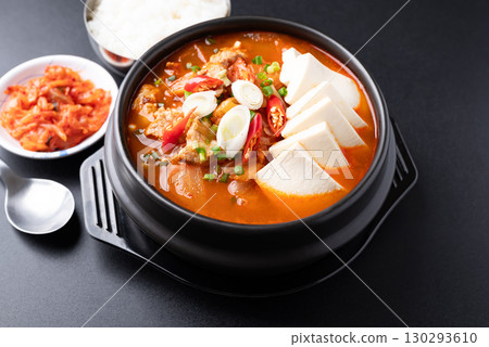 Korean food (Kimchi Jjigae), Kimchi soup with tofu and pork in bowl eating with rice and kimchi Korean food (Kimchi Jjigae), Kimchi soup with tofu and pork in bowl eating with rice and kimchi 130293610