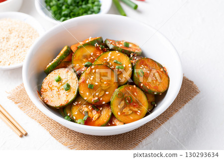 Korean cucumber salad (Oi muchim) in bowl on white background, Korean side dish Korean cucumber salad (Oi muchim) in bowl on white background, Korean side dish 130293634