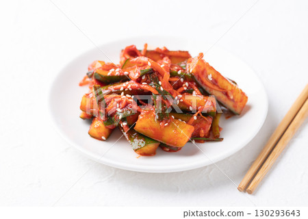 Korean kimchi cucumber on white plate with chopsticks, Korean side dish, Homemade food 130293643