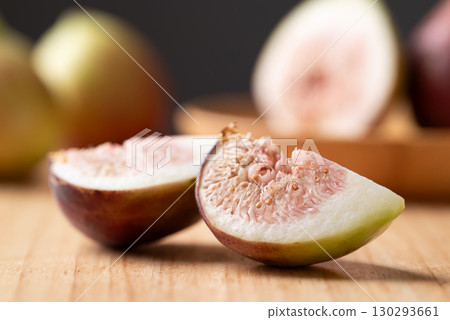 Fresh sliced fig on cutting wooden board, Autumn fruit Fresh sliced fig on cutting wooden board, Autumn fruit 130293661