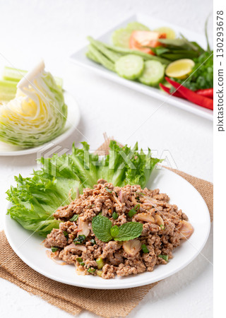 Local Thai food, Spicy minced pork salad (Larb Moo) eating with fresh vegetables on white background 130293678